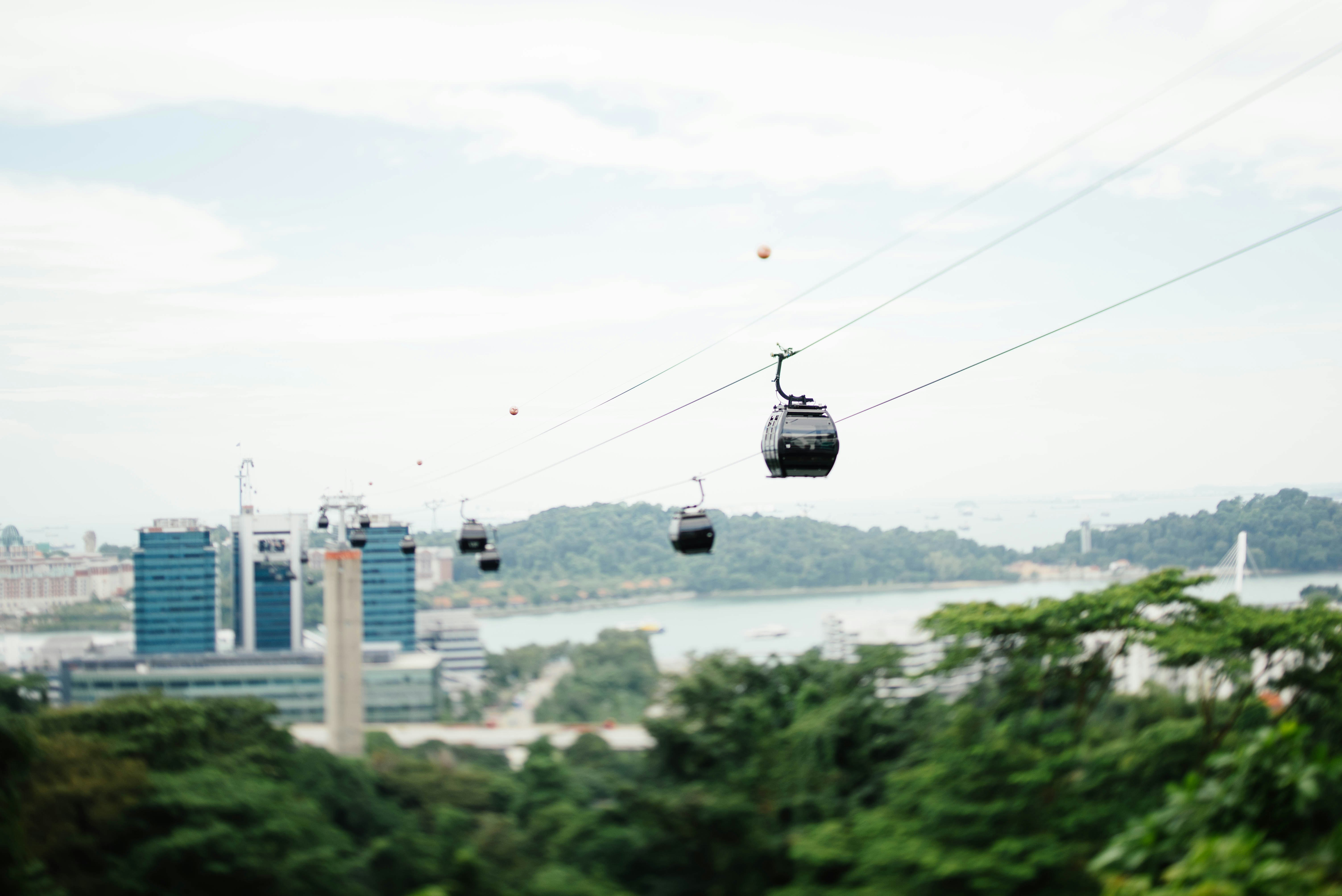 four white cable cars near blue building